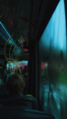 people riding on a bus at night with blurry lights from the windows and doors