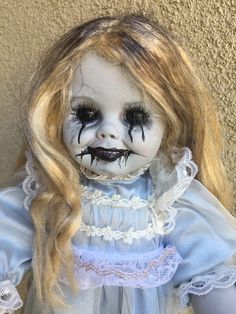 a creepy doll with makeup on her face