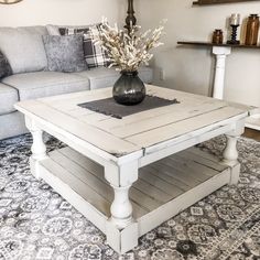 a living room with a couch, coffee table and other items on the carpeted floor