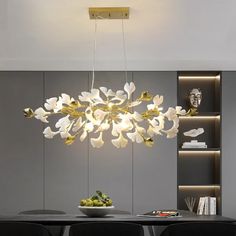 a modern chandelier hanging over a dining room table