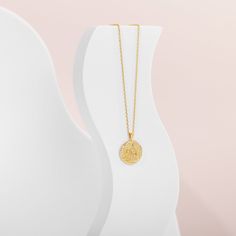 A trendy necklace that never goes out of style. The PAVOI 14K gold plated engraved coin pendant features a byzantine-style coin with a reversible design, showcasing a moon and star on one side and a sun and moon on the other. Hanging on a cable chain, this pendant necklace adds the perfect boho-chic touch. Materials: Measurements: Chain Length: 20"+ adjustable chain slide. Pendant size is 18mm (.7") diameter. Gold Plated Engraved Coin Medallion Necklace, Engraved Coin Medallion Gold Plated Necklace, Gold Medallion Necklace With Engraved Initial Pendant, Gold Engraved Initial Pendant Medallion Necklace, Gold Engraved Round Pendant Coin Necklace, Gold Engraved Round Disc Coin Necklace, Gold Engraved Amulet Coin Necklace, Gold Plated Engraved Medallion Pendant Necklace, Spiritual Gold Plated Engraved Coin Necklace