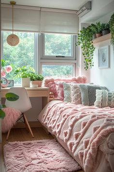 a bedroom with pink bedding and plants on the window sill, along with a desk