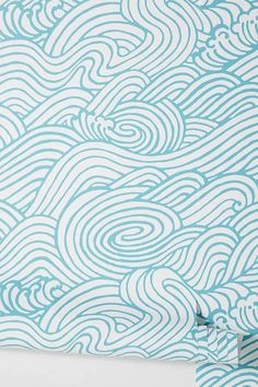 a blue and white wallpaper with wavy waves on the side, in front of a white background