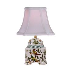 a white lamp with a bird on it and a pink shade over the light fixture