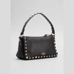 Valentino Garavani shoulder bag in calf leather with Rockstud trim. Flat top handle. Detachable, adjustable shoulder strap. Zip top and flip-lock tab closures. Interior, one slip pocket. Made in Italy. Luxury Rectangular Bags With Studs, Elegant Studded Shoulder Bag For Everyday Use, Luxury Studs Bags For Everyday, Leather Evening Bag With Rivets, Evening Leather Bag With Rivets, Designer Bags With Rivets, Elegant Evening Shoulder Bag With Rivets, Studded Evening Shoulder Bag, Luxury Studded Shoulder Bag