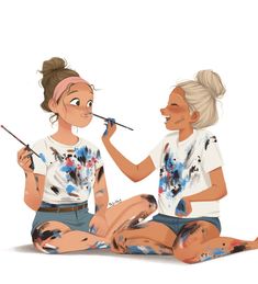 two women sitting on the ground with paintbrushes in their mouths and one is brushing her teeth