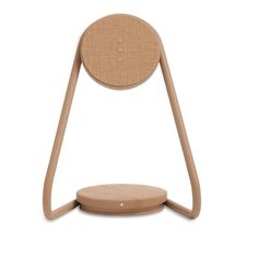 a wooden chair with a circular seat on it's back legs and an object in the middle