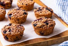 muffins on a wooden tray with blue and white checkered cloth