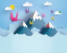 origami birds flying in the sky over mountains