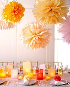 the table is set up with paper pom - poms