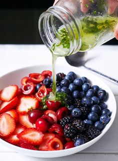 a bowl filled with berries, strawberries and blueberries