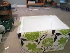 a green and white ottoman sitting on top of a floor