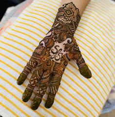 a henna on someone's hand with intricate designs