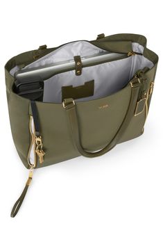 an olive green handbag with gold handles