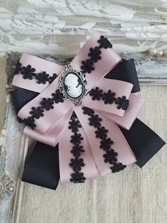 Victorian Pink Brooches For Wedding, Black Brooch With Decorative Bow Gift, Black Brooch With Decorative Bow As Gift, Black Ribbon Brooches As Gift, Black Ribbon Brooches For Gift, Vintage Bow Tie Brooch As Gift, Elegant Pink Bow For Gift, Black Bow Tie Brooches For Wedding, Black Bow Tie Brooch For Wedding