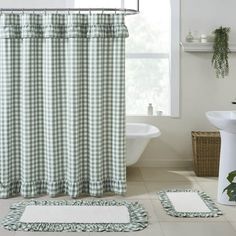 a green and white checkered shower curtain next to a bathtub in a bathroom