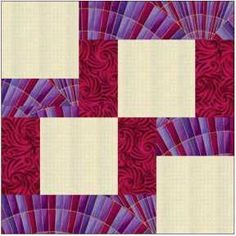 an image of a red and purple quilt with white squares on the front, along with two smaller squares in the middle