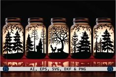 four mason jars with trees and deer silhouettes on them