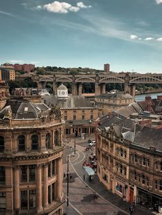 an aerial view of the city with bridges in the background