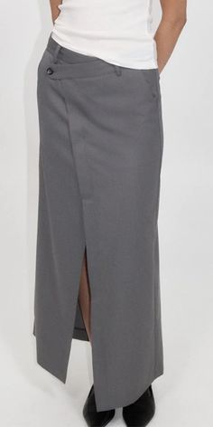 The St. Agni Deconstructed Waist Maxi Skirt elevates timeless men's tailoring with a playful feminine twist. Made from responsibly sourced wool blend, this Pewter Grey skirt features an asymmetric waist, front and back split, and a tailored mid-rise fit. Stay refined yet casual with this versatile piece. Details: Color: Pewter Grey 50% RWS Wool / 50% Recycled Poly Lining: 100% lyocell Asymmetric waist detail Center front and back split at hem Vendor Code: W24-802PGR Fits true to size Model is 5ft 5in and is wearing a size XS Grey Skirt, St Agni, Pewter Grey, Blue Flats, Gray Skirt, Australian Design, Resort Wear, Long Skirt, Wide Leg Pants