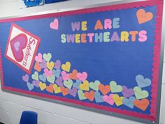 a bulletin board with hearts and we are sweethearts written on the wall in front of it