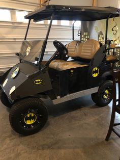 a batman golf cart is parked in a garage