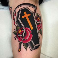 a cross and roses tattoo on the arm, with an arrow in the center that is next to it