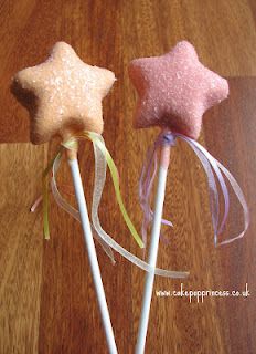 two star shaped lollipops sitting on top of a wooden table