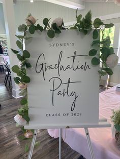 a sign that says graduation party class of 2013 with flowers and greenery on it