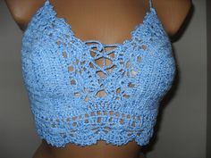 a crocheted blue bra top on a mannequin headdress is shown