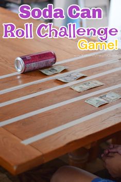 a child sitting at a table with some cards on it and the words soda can roll challenge game