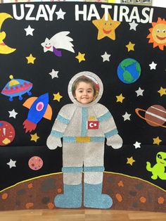 a child in an astronaut suit is standing on the moon with other children's artwork