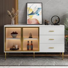 a white and gold sideboard with wine bottles on the bottom shelf next to a potted plant