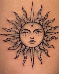 a sun tattoo on the back of a woman's thigh