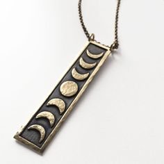 Celestial Moon Phase Brass Necklace, Spiritual Brass Moon Phase Necklace, Celestial Brass Moon Phase Necklace, Celestial Brass Moon Phase Necklaces, Celestial Moon-shaped Jewelry For Meditation, Celestial Moon Jewelry For Meditation, Celestial Brass Necklace With Moon Phase, Celestial Brass Necklace With Moon Phase Detail, Spiritual Brass Necklace With Moon Phase