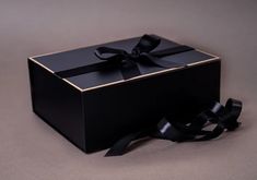 a black box with a ribbon tied around it