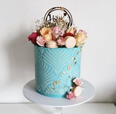 there is a blue cake with flowers in it