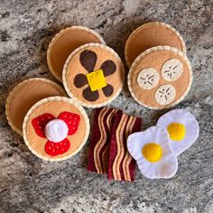 four felt food items sitting on top of a granite countertop next to each other