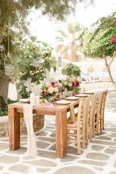 a wooden table topped with lots of flowers