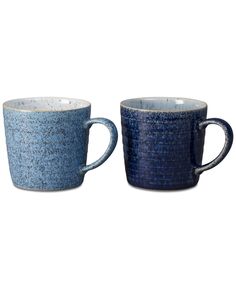 two blue mugs sitting next to each other