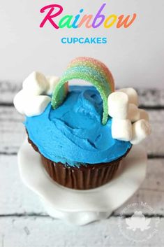 a cupcake with blue icing and marshmallows on top