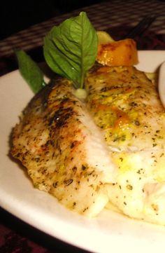 a white plate topped with meat and vegetables