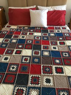 a crocheted bed with red, white and blue bedspread on it