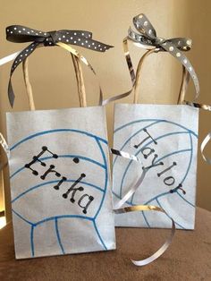 two paper bags with writing on them sitting on a table