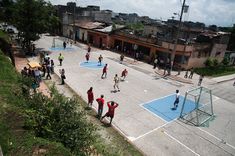 people are playing basketball on an outdoor court