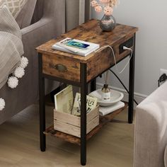 a small wooden table with books and magazines on it next to a couch in a living room