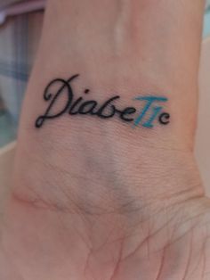 a small wrist tattoo with the word diasse on it