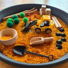 a bowl filled with yellow rice and toys