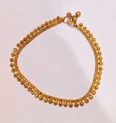 22k Solid Gold Anklet-Real Gold Anklet-Payal Anklet-Indian Gold Anklet-Gold ball Anklet-Vintage Gold Anklet-Indian Gold Payal Handmade Designer Indian Look Ghunghroo rajasthani 22K Gold Anklet. PRODUCT SPECIFICATION: Material: 22k Solid Gold Hallmarking: 22k916 Hallmarked tested in indian Gold Testing Lab. Size: Standard Ankle size. Weight one piece: 14 gram ( approx) Theme: Dangling Ghunghroo design Price shown for one piece. Customer Satisfaction is our utmost priority, feel free to have any q Gold Anklets With Round Beads For Festival, Gold Toe Ring Anklets For Festival, Traditional Gold Anklets For Festivals, Gold Ankle Wrap Bracelets For Festivals, Handmade Gold Toe Ring Anklets, Adjustable Gold Anklets With Latkans, Elegant Gold Anklets For Puja, Gold Anklets With Latkans For Festival, Gold Anklets For Party And Festivals