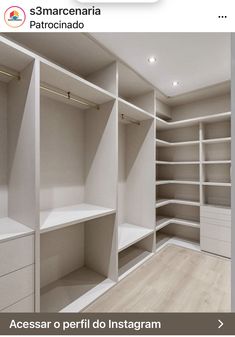 an empty walk in closet with white shelving